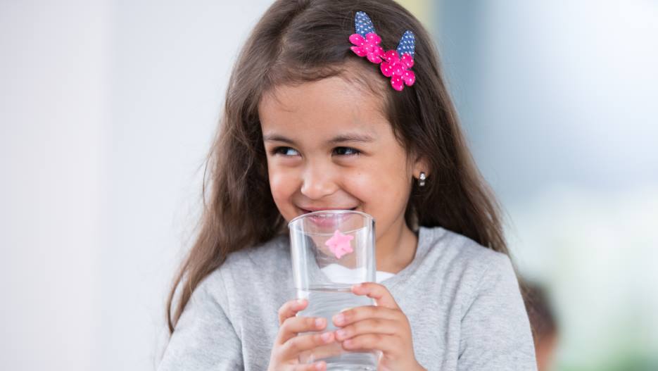 girl drinking a cup of water