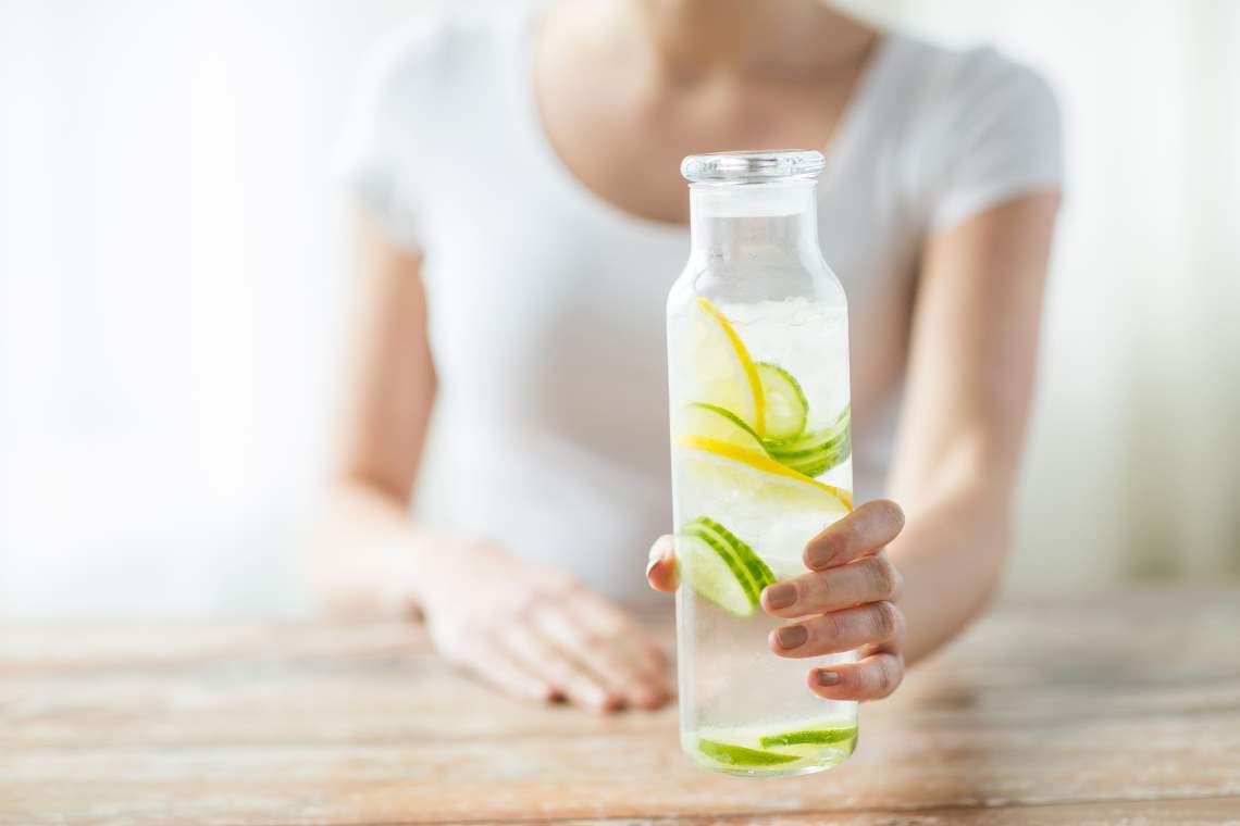 woman drinking a cup of water